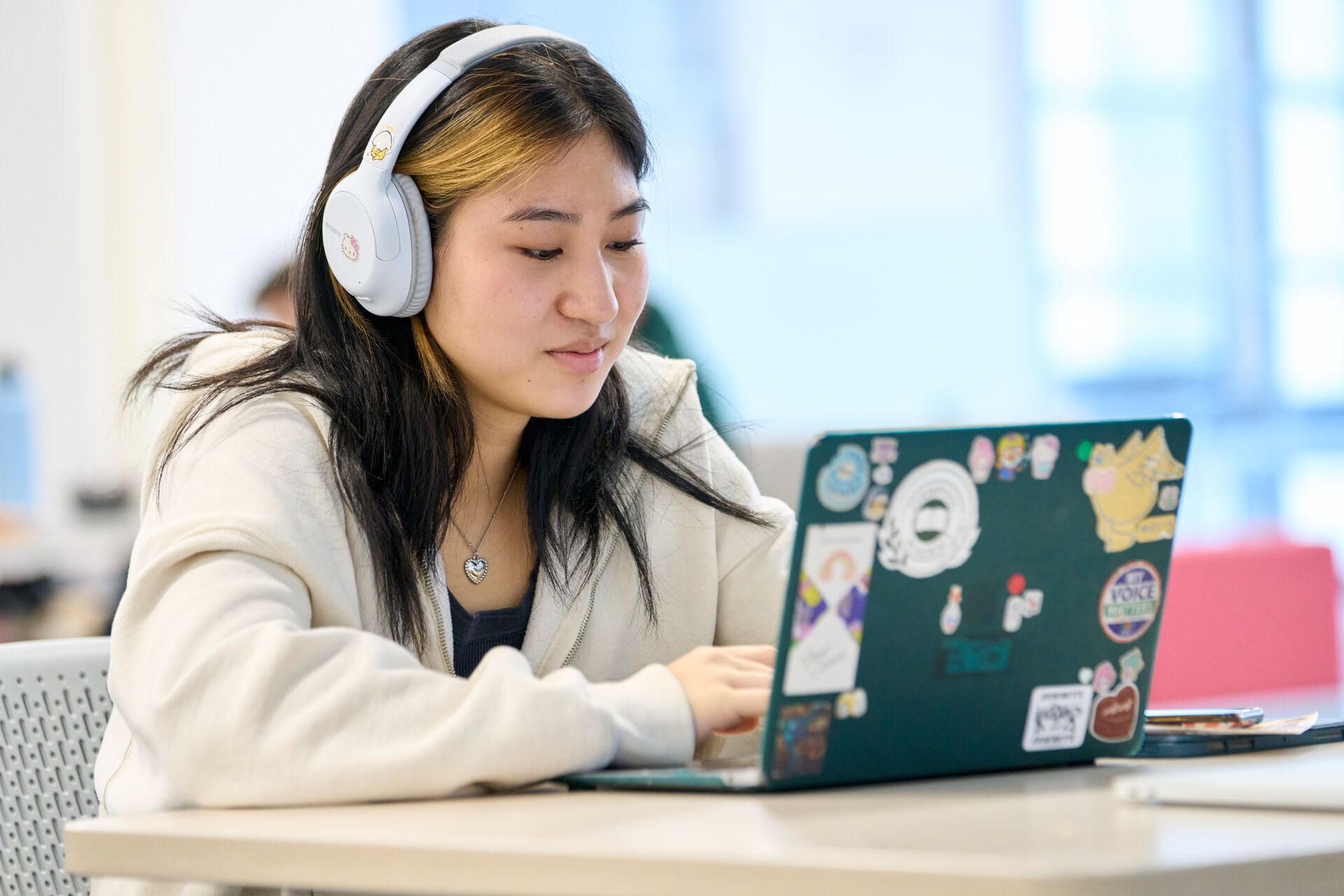 Female student looking at laptop.